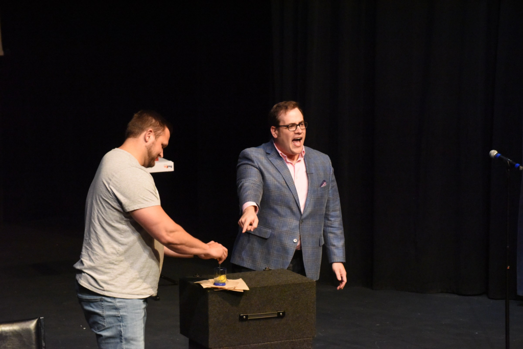 Scott Green performing with a volunteer