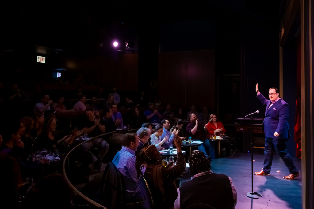 Scott Green on stage at a comedy club